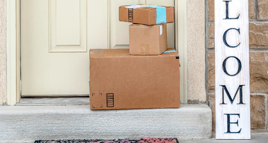 Packages on the doorstep of a home with a welcome sign in Dover